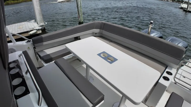 Slide: The Image of 2022 Jeanneau Leader 9.0 WA boat with spacious seating and table on deck. - 10