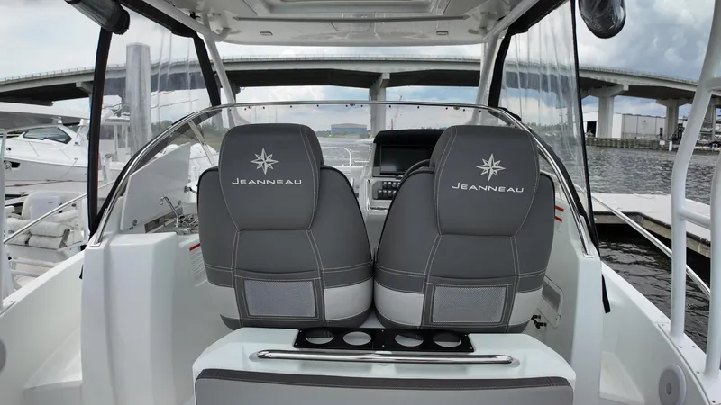 Slide: The Image of 2022 Jeanneau Leader 9.0 WA boat interior with dual seats and dashboard view. - 11