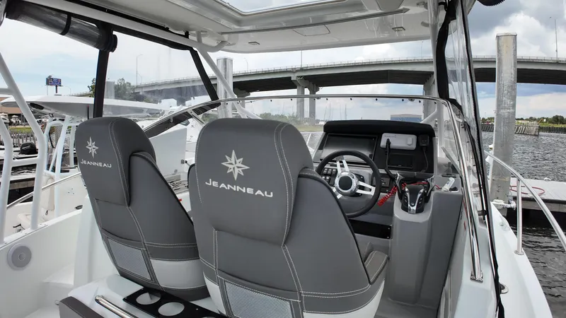Slide: The Image of 2022 Jeanneau Leader 9.0 WA boat interior with steering wheel and seats. - 12
