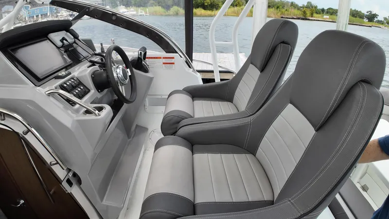 Slide: The Image of 2022 Jeanneau Leader 9.0 WA cockpit with dual gray seats and modern dashboard. - 13