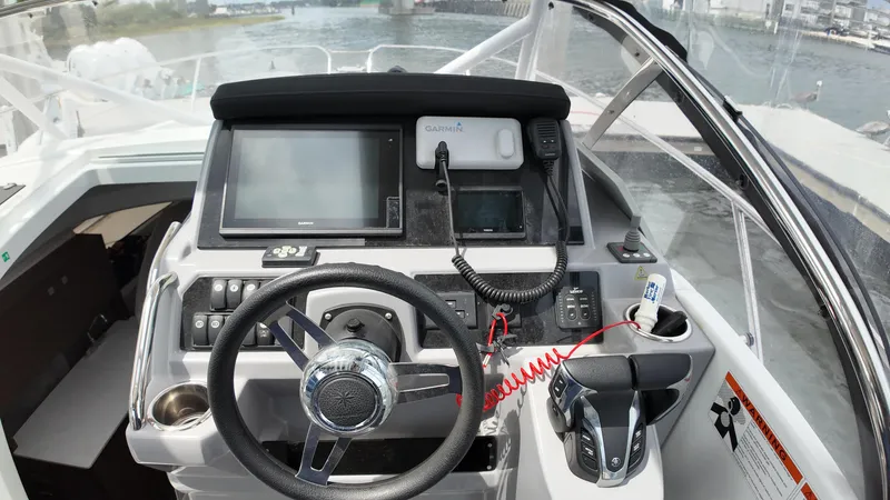 Slide: The Image of 2022 Jeanneau Leader 9.0 WA helm with modern navigation equipment and steering wheel. - 14