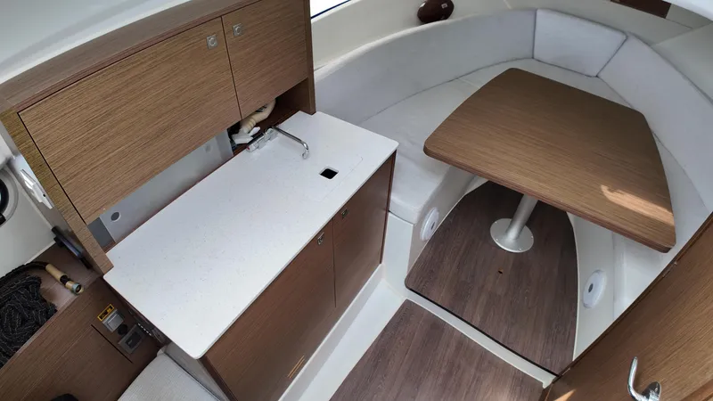 Slide: The Image of 2022 Jeanneau Leader 9.0 WA interior with kitchenette and seating area. - 17