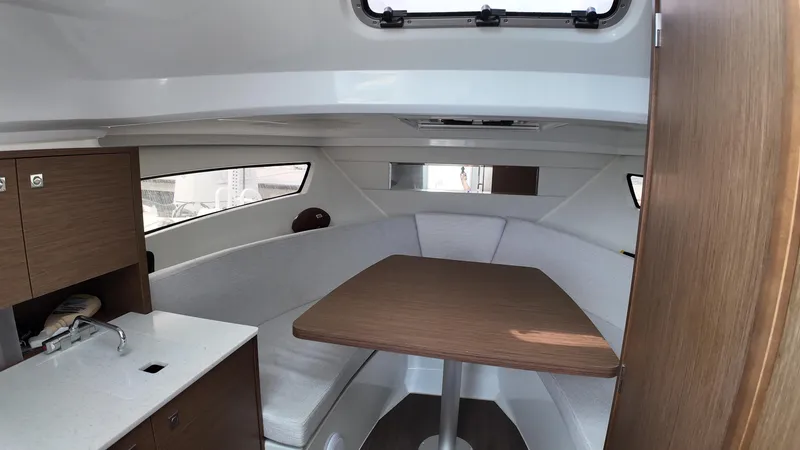 Slide: The Image of Interior of 2022 Jeanneau Leader 9.0 WA boat with seating and table. - 18