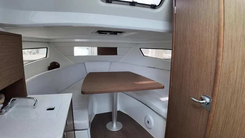 Slide: The Image of 2022 Jeanneau Leader 9.0 WA cabin interior with seating and table. - 19