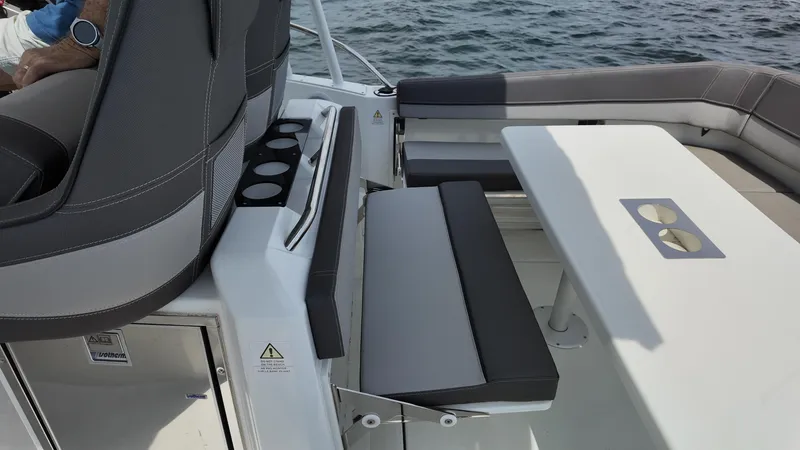 Slide: The Image of 2022 Jeanneau Leader 9.0 WA boat interior with seating and table on the water. - 23