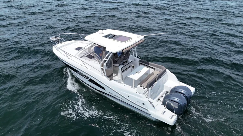 Slide: The Image of 2022 Jeanneau Leader 9.0 WA cruising on open water, featuring twin engines and sleek design. - 3