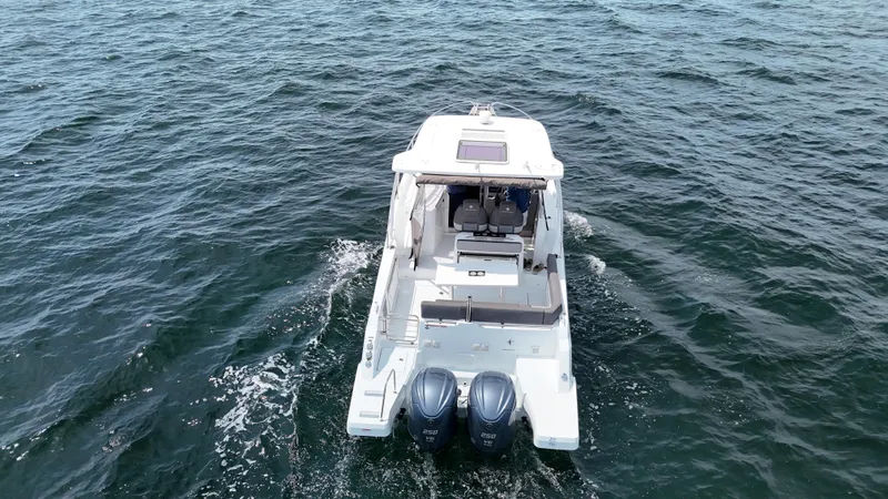 Slide: The Image of 2022 Jeanneau Leader 9.0 WA cruising on open water, rear view. - 5