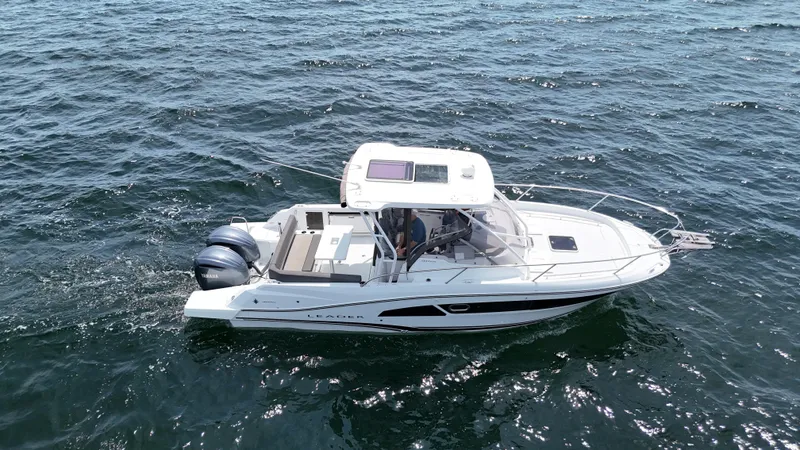 Slide: The Image of 2022 Jeanneau Leader 9.0 WA cruising on open water, side view. - 7