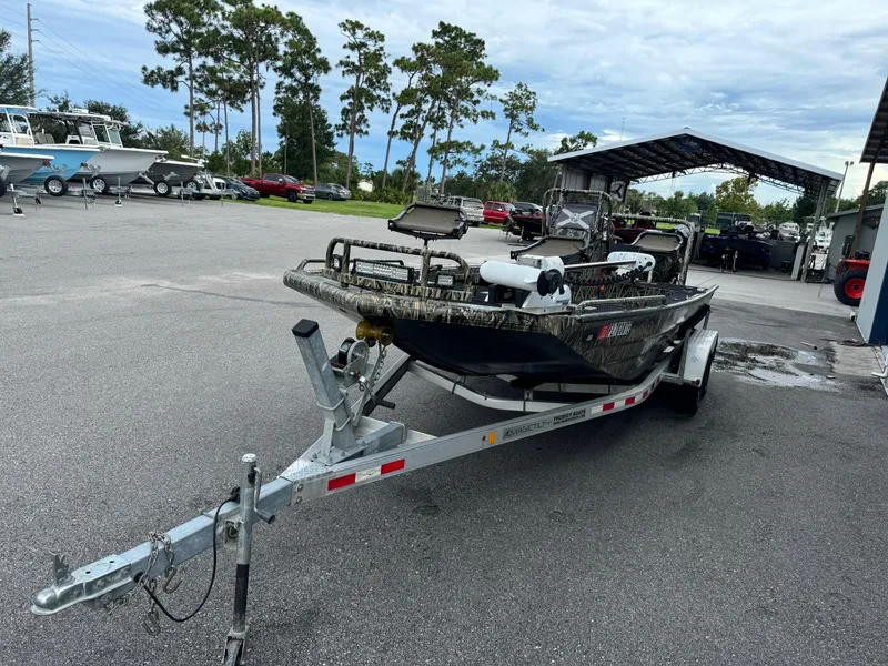 Slide: The Image of 2018 Prodigy 2172 Marsh Turf C boat on trailer in parking lot. - 3