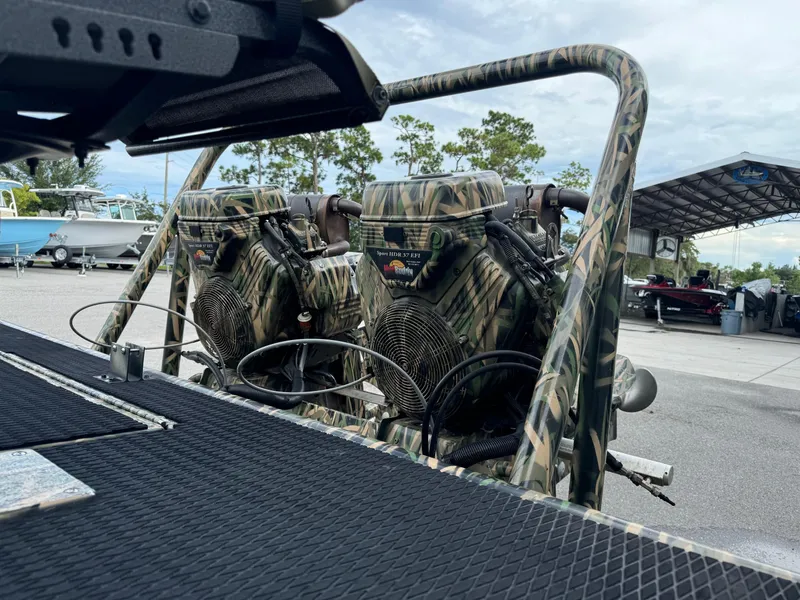 Slide: The Image of Camouflage-patterned Prodigy 2172 MARSH TURF C boat engines, 2018 model, in a marina setting. - 5