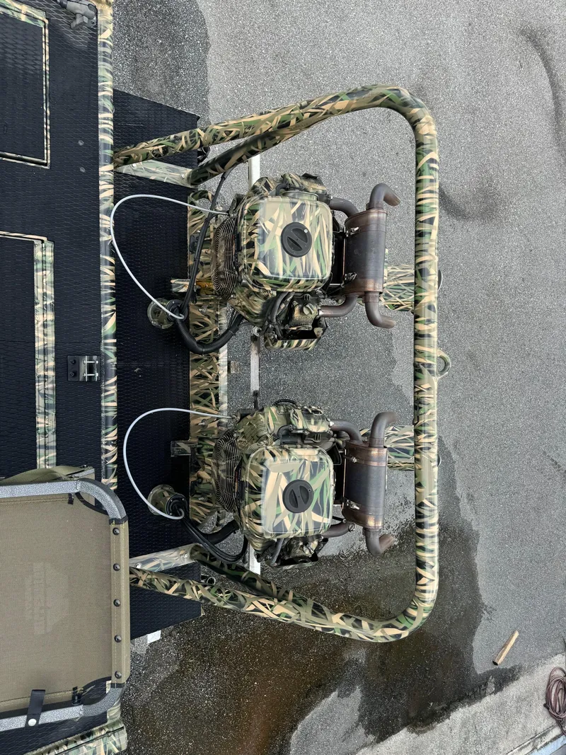 Slide: The Image of 2018 Prodigy 2172 Marsh Turf C with dual camo engines on wet surface. - 7