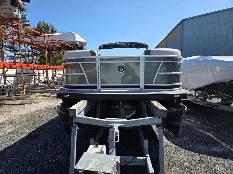 Slide: The Image of 2025 Godfrey Sweetwater 2286 C pontoon boat on trailer, outdoor storage area. - 1