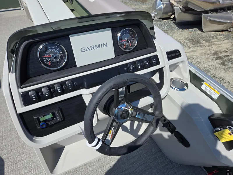 Slide: The Image of Dashboard of 2025 Godfrey Sweetwater 2286 C boat with Garmin display and steering wheel. - 13