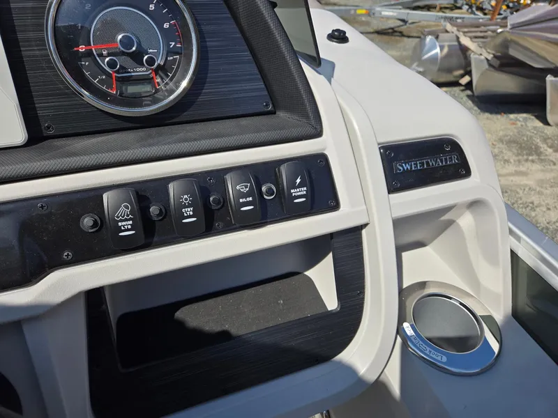 Slide: The Image of Dashboard of 2025 Godfrey Sweetwater 2286 C boat with control panel and cup holder. - 16