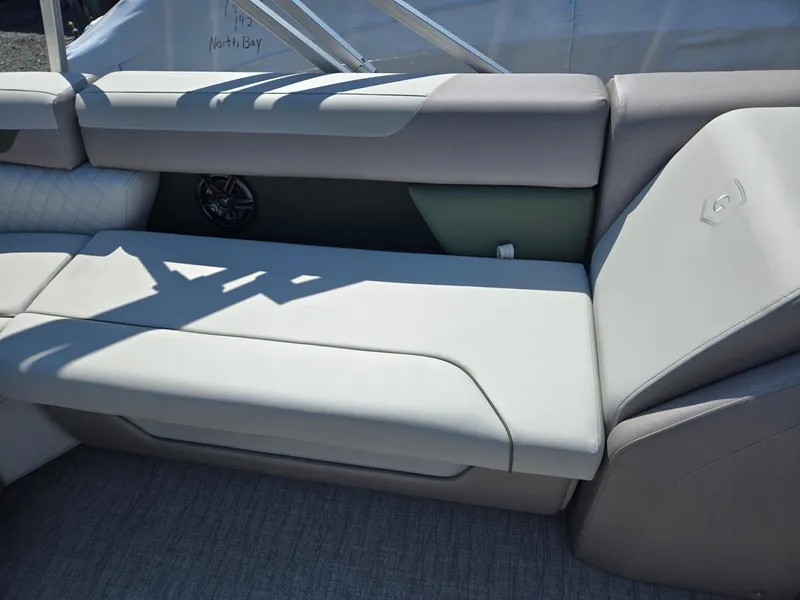 Slide: The Image of 2025 Godfrey Sweetwater 2286 C boat interior with cushioned seating and speaker. - 22