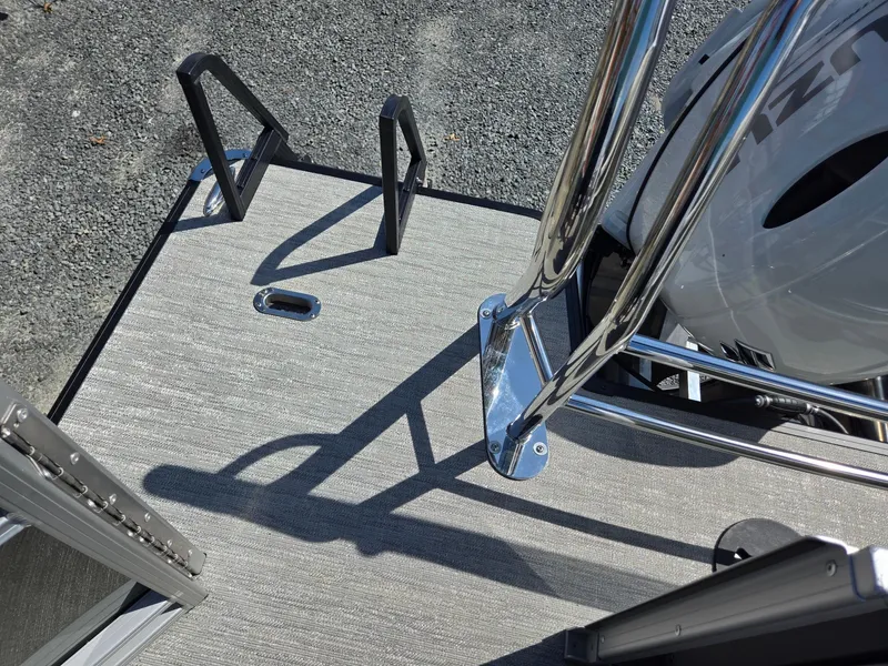 Slide: The Image of 2025 Godfrey Sweetwater 2286 C boat deck with chrome railing and motor. - 26