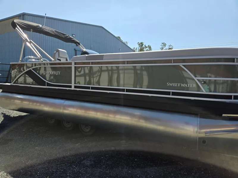 Slide: The Image of 2025 Godfrey Sweetwater 2286 C pontoon boat parked outdoors. - 3