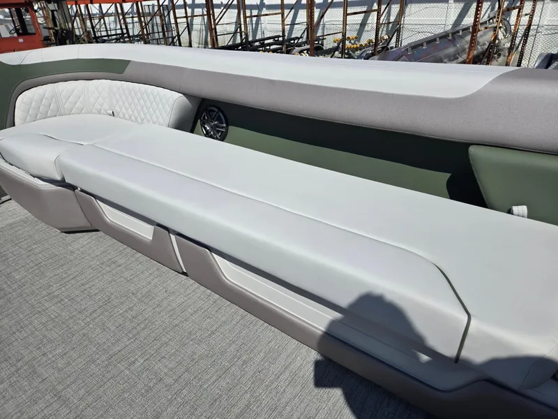 Slide: The Image of 2025 Godfrey Sweetwater 2286 C boat interior with cushioned seating and speaker. - 34
