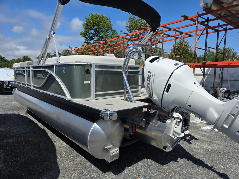 Slide: The Image of 2025 Godfrey Sweetwater 2286 C pontoon boat with Suzuki outboard motor, parked outdoors. - 6