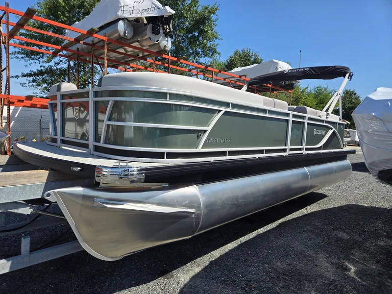 Slide: The Image of 2025 Godfrey Sweetwater 2286 C pontoon boat on display outdoors. - 7