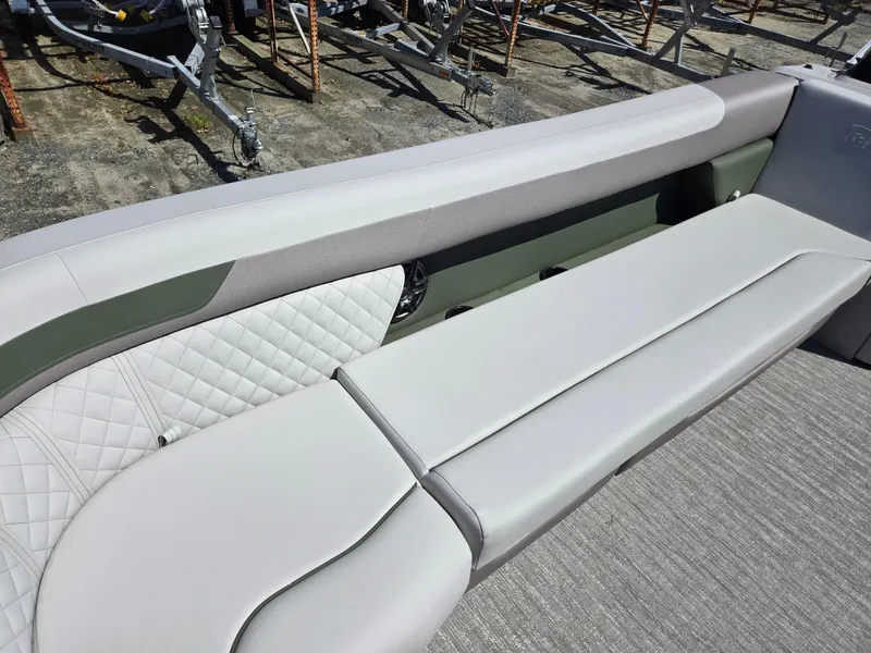 Slide: The Image of 2025 Godfrey Sweetwater 2286 C boat interior with cushioned seating and quilted design. - 9