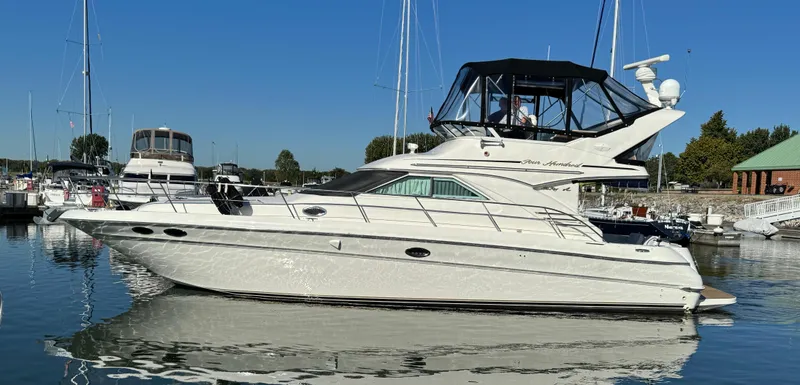 Slide: The Image of 2001 Sea Ray 400 Sedan Bridge yacht docked in a marina. - 0