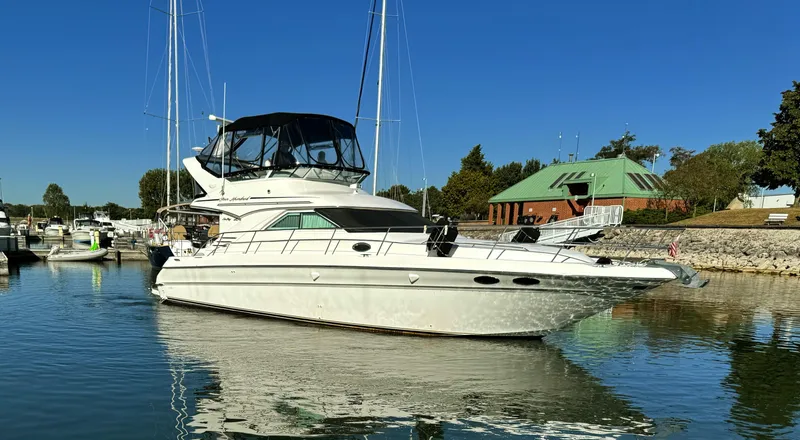 Slide: The Image of 2001 Sea Ray 400 Sedan Bridge yacht docked in a marina. - 1