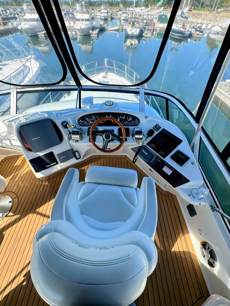 Slide: The Image of Interior view of 2001 Sea Ray 400 Sedan Bridge yacht helm station. - 12