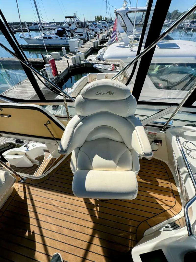 Slide: The Image of Captain's chair on 2001 Sea Ray 400 Sedan Bridge yacht, docked at marina. - 14