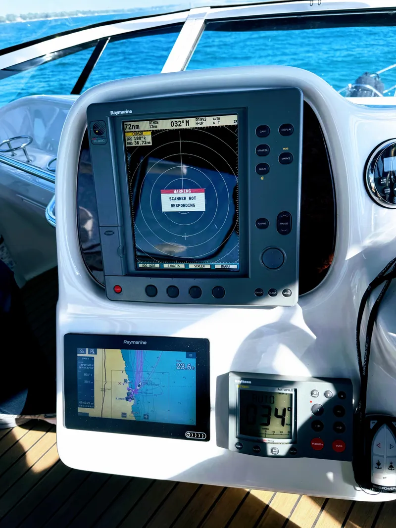Slide: The Image of 2001 Sea Ray 400 Sedan Bridge navigation system with radar and GPS displays. - 15