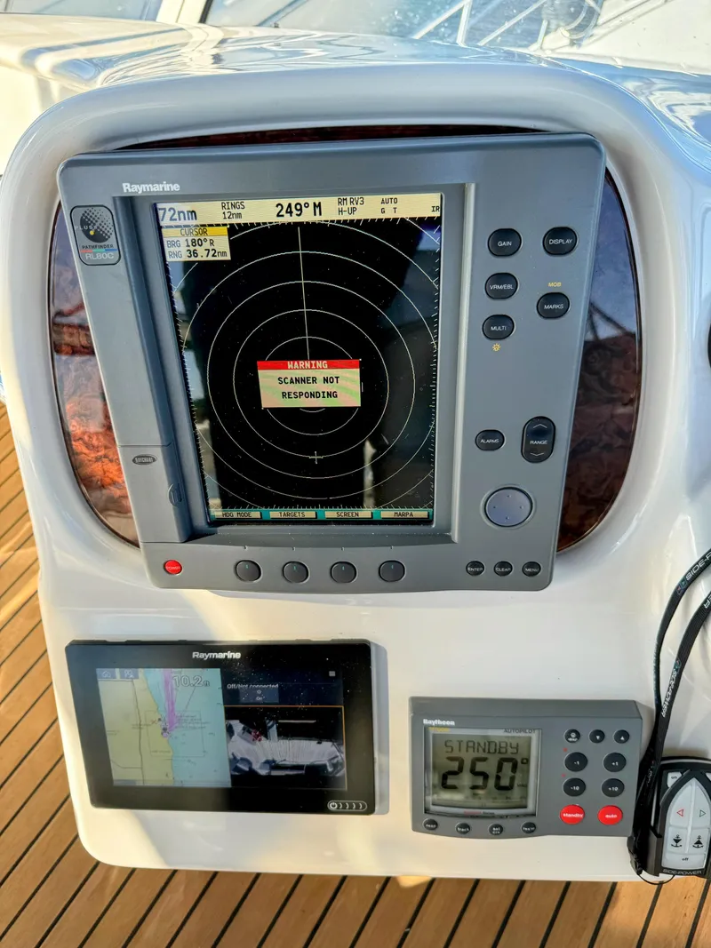 Slide: The Image of Sea Ray 400 Sedan Bridge 2001 dashboard with radar warning, navigation equipment. - 16