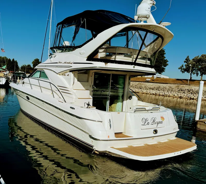 Slide: The Image of 2001 Sea Ray 400 Sedan Bridge yacht docked in a marina. - 2