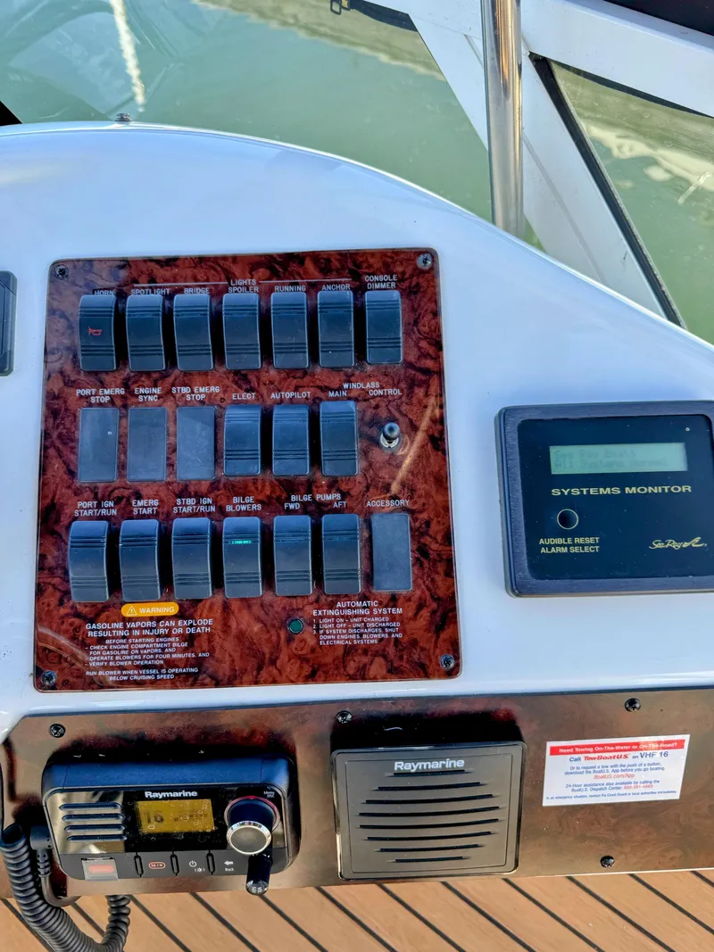 Slide: The Image of Control panel of 2001 Sea Ray 400 Sedan Bridge with switches and systems monitor. - 20