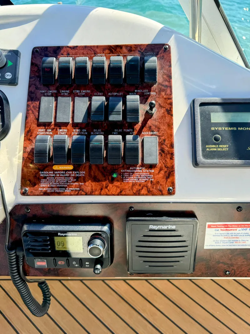 Slide: The Image of Control panel of 2001 Sea Ray 400 Sedan Bridge yacht with switches and Raymarine equipment. - 21