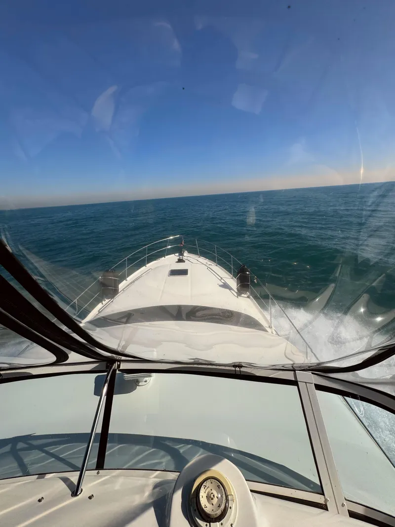 Slide: The Image of 2001 Sea Ray 400 Sedan Bridge cruising on open water under clear blue skies. - 25