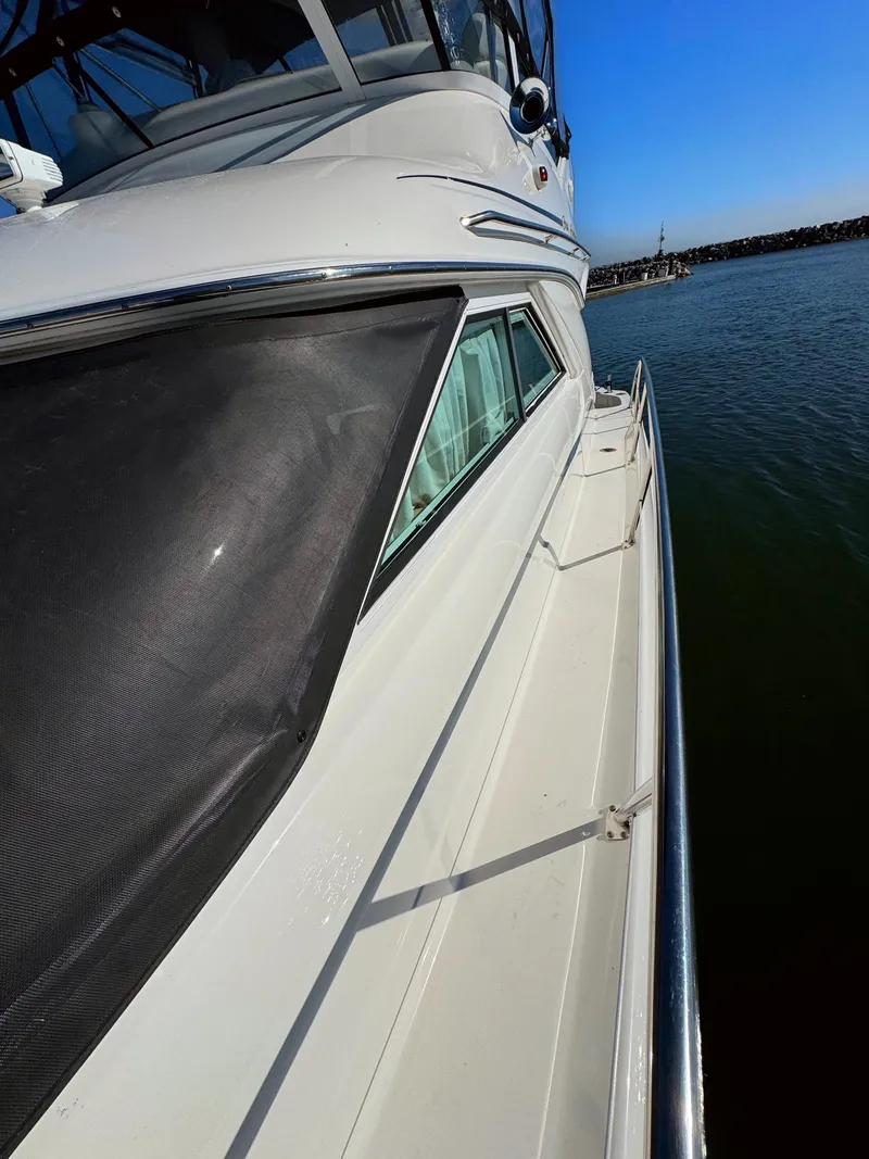 Slide: The Image of 2001 Sea Ray 400 Sedan Bridge yacht on calm water, side view. - 27