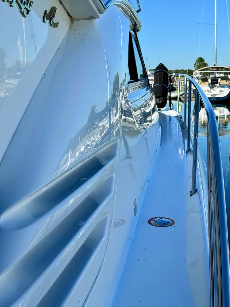 Slide: The Image of 2001 Sea Ray 400 Sedan Bridge yacht, sleek design, docked in marina. - 28