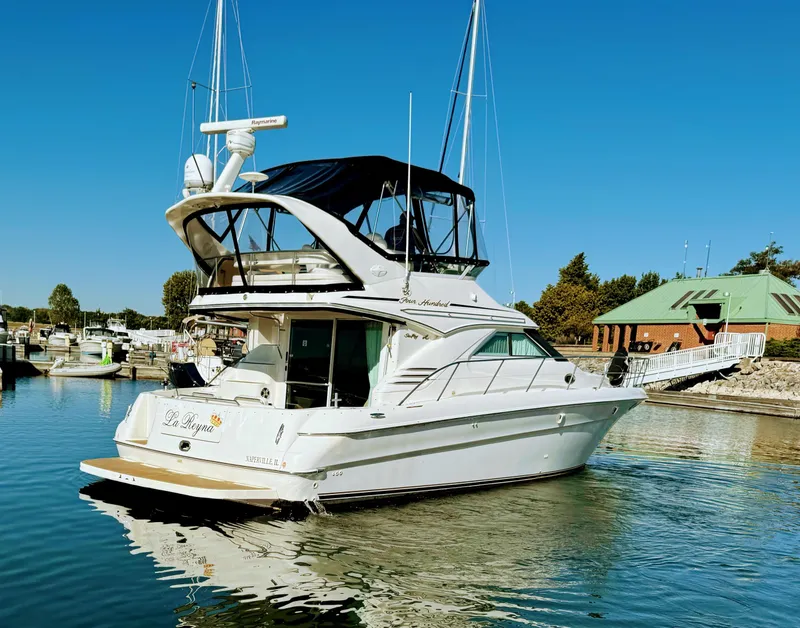 Slide: The Image of 2001 Sea Ray 400 Sedan Bridge yacht docked in a marina under clear blue skies. - 3