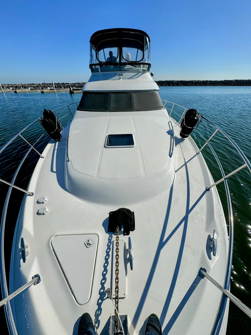 Slide: The Image of 2001 Sea Ray 400 Sedan Bridge yacht on calm water, sunny day. - 30