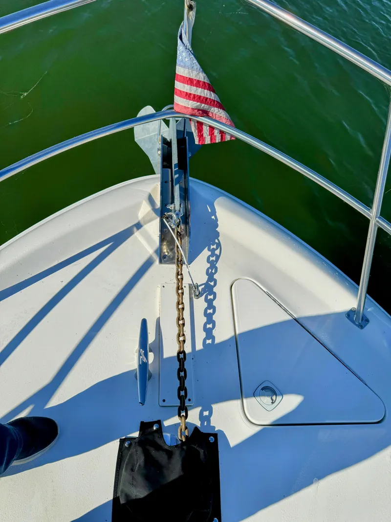 Slide: The Image of Bow of 2001 Sea Ray 400 Sedan Bridge with anchor and American flag. - 31