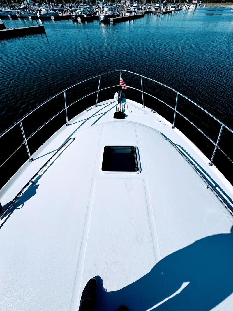 Slide: The Image of Bow view of 2001 Sea Ray 400 Sedan Bridge in marina. - 32