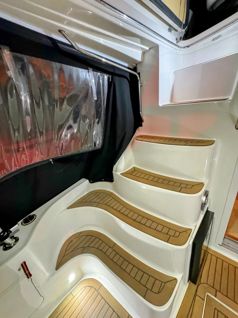 Slide: The Image of Staircase on 2001 Sea Ray 400 Sedan Bridge yacht with wood accents. - 33