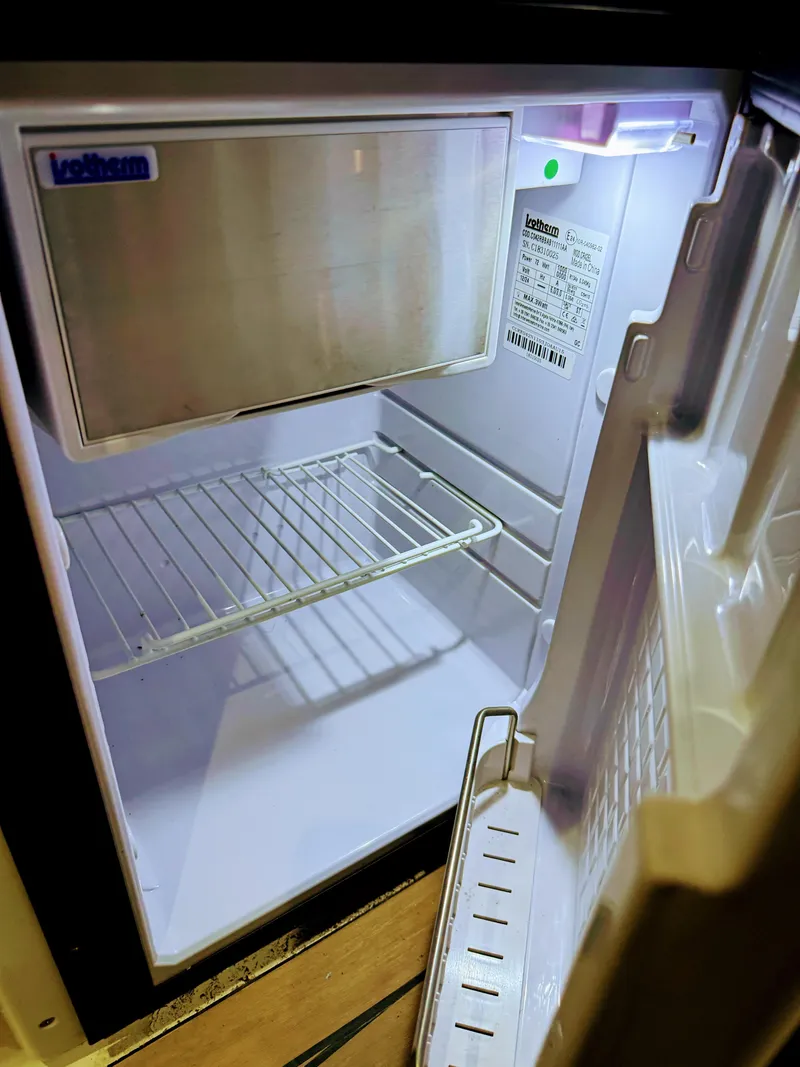 Slide: The Image of Empty mini fridge inside 2001 Sea Ray 400 Sedan Bridge yacht. - 34