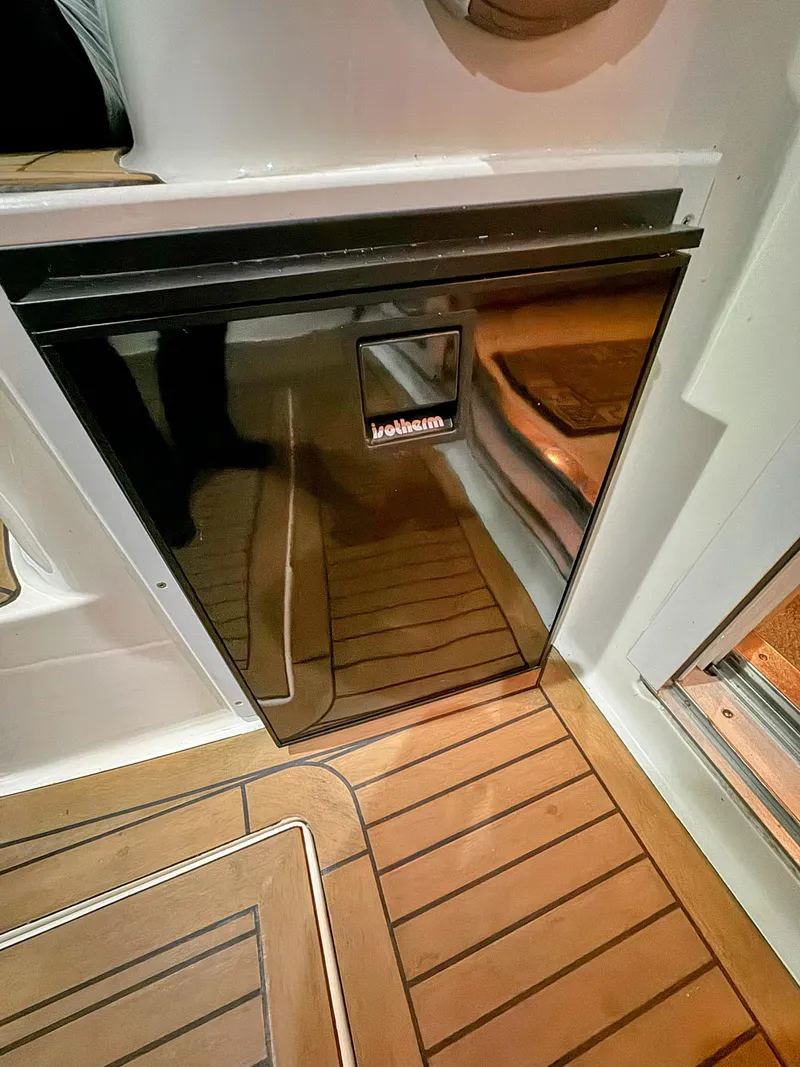 Slide: The Image of Black Jollem fridge on 2001 Sea Ray 400 Sedan Bridge yacht with wooden flooring. - 35