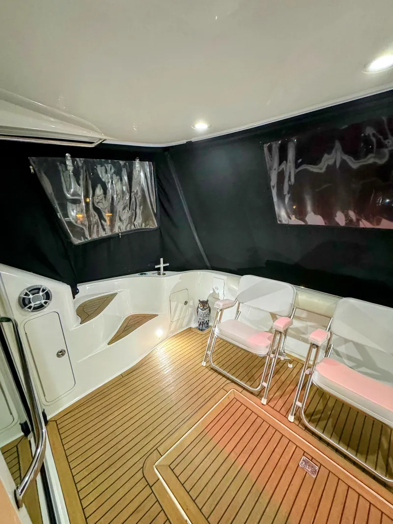 Slide: The Image of Interior of 2001 Sea Ray 400 Sedan Bridge with seating and wood flooring. - 36