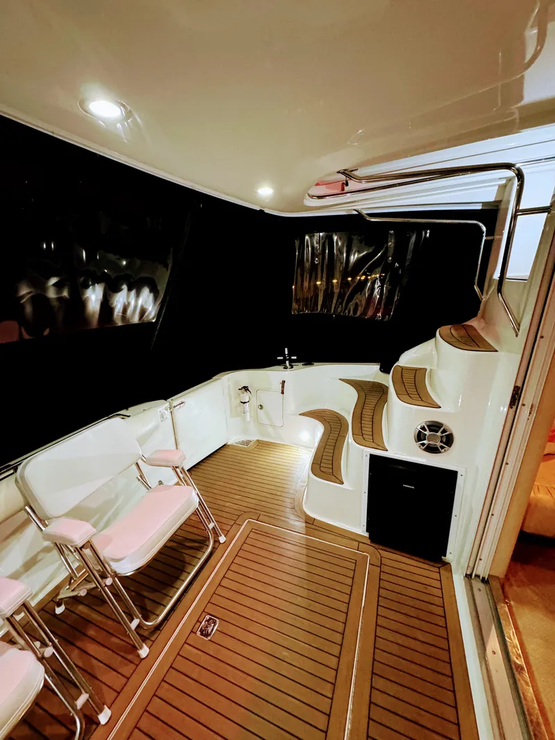 Slide: The Image of Interior of 2001 Sea Ray 400 Sedan Bridge with seating and wooden flooring. - 37