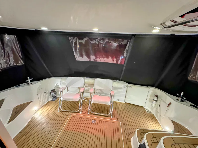 Slide: The Image of Interior of 2001 Sea Ray 400 Sedan Bridge with seating and wood flooring. - 38