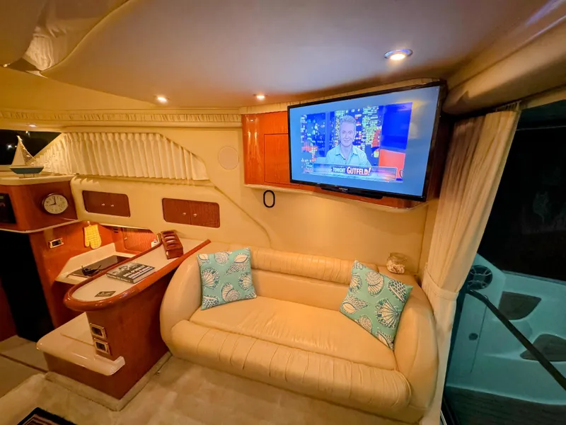 Slide: The Image of Interior of 2001 Sea Ray 400 Sedan Bridge with TV, sofa, and nautical decor. - 40