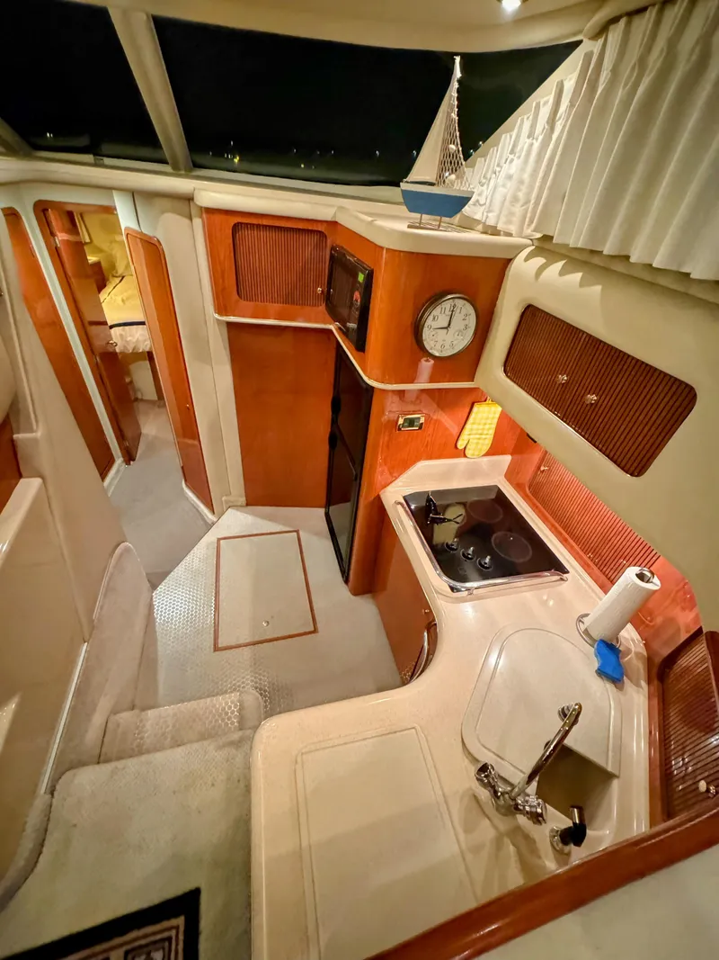 Slide: The Image of Interior of 2001 Sea Ray 400 Sedan Bridge yacht with kitchen and cozy cabin. - 45