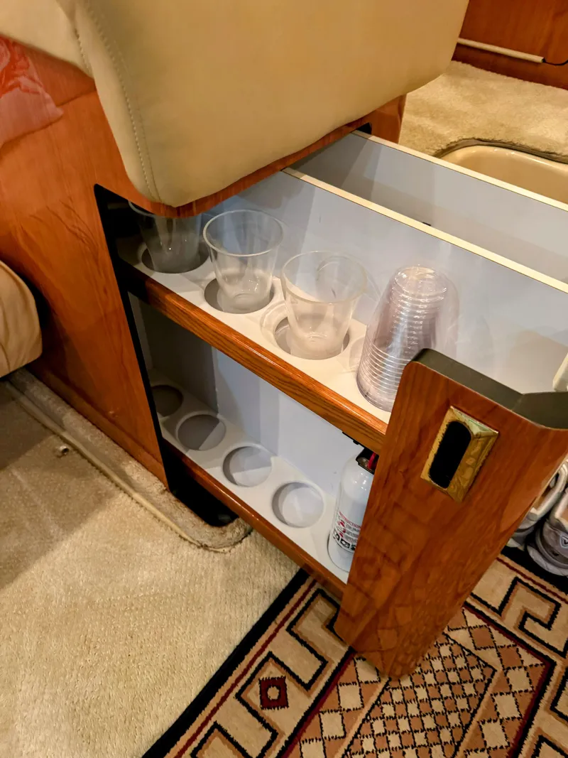 Slide: The Image of 2001 Sea Ray 400 Sedan Bridge interior with built-in cup holder and storage. - 48